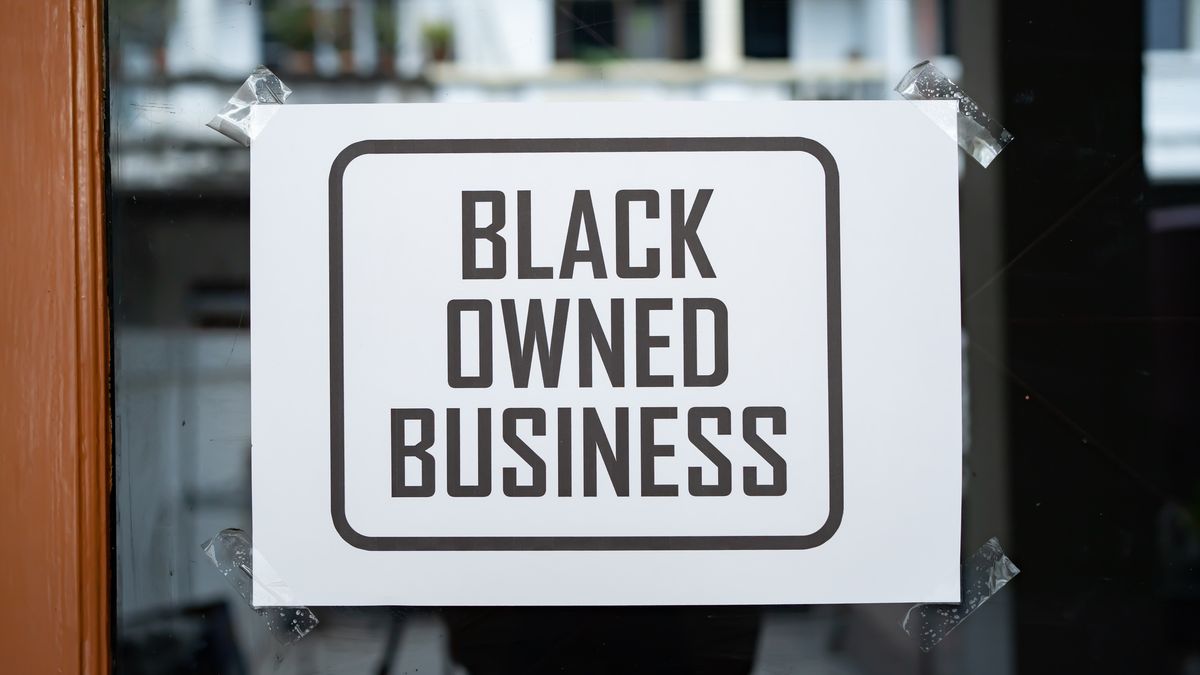 "Black Owned Business" sign in a window